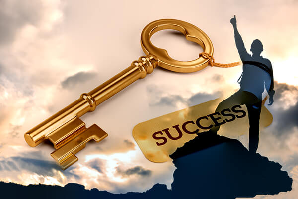 Man standing on mountain wait arm raised white gold key the says success