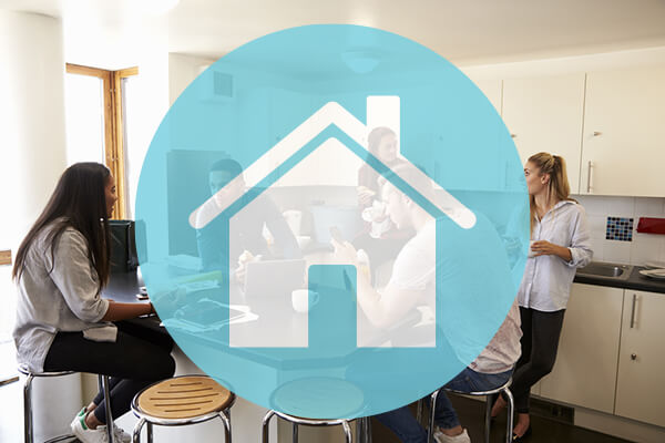 people sitting in kitchen talking with icon of blue house covering picture